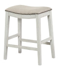 24-Inch Counter Height Saddle Stool 2-Pack With Nailhead Trim Thick Padded Beige Fabric Seats Antique White Base Perfect For Breakfast Nook Or Kitchen Bar Stools Assembly Required, side view showing beige padded seat with nailhead trim.