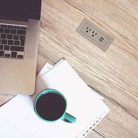 Radiant Furniture Power Center With USB recessed power strip on wooden desk by laptop and coffee, nickel finish charging hub