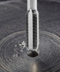 Close-up of tap cutting thread into metal using Heavy Duty 80 Piece Tap And Die Set With SAE And Metric Threads In 52100 Bearing Steel CNC Machined