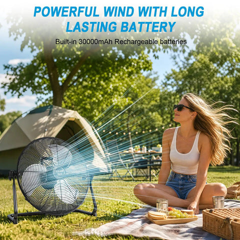 Woman relaxing near 18 Inch Solar Powered Outdoor Fan With 40W Panel And 30000mAh Battery, quiet portable fan in use.
