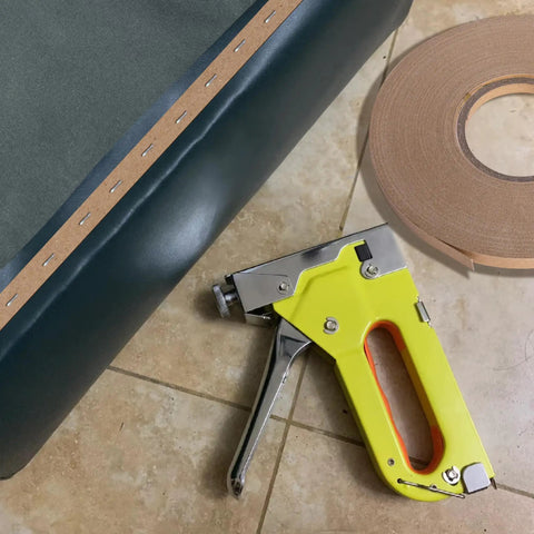 Rock Solid 33 Yards Upholstery Tack Strips For Couch Furniture Edge Fixation with staple gun and roll on a tiled surface.