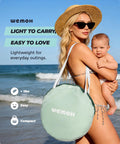 Woman holding baby with Pop Up Baby Beach Tent With UPF 50+ Sun Shade Mosquito Net Shelter in carry bag on beach