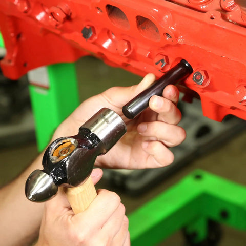 Installing Spark Plug Saver Inserts For Thread Repair M14 1.25 14mm Rethread Kit with hammer and tool on engine block