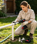 Woman using Pro Grade Alloy Pipe Threader And Trimmer on white pipes outdoors, preparing for plumbing tasks.