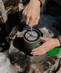 Silicone French Press Coffee Maker For Camping Stoves Regular Size Travel Ready Brew On The Go used on a tree stump outdoors