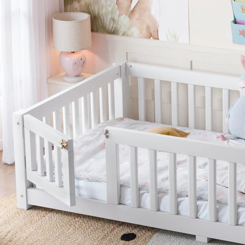 Totally Built Tough Twin Floor Bed With Montessori Design And Complete Safety Guardrails Plus Easy Access Door For Kids, Solid Wood Low Profile Slatted Frame In Fresh White in a bright nursery setting.