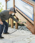 Man using Professional HEA Airless Paint Sprayer That Slashes Overspray And Delivers A Hella Smooth Finish on deck stairs.