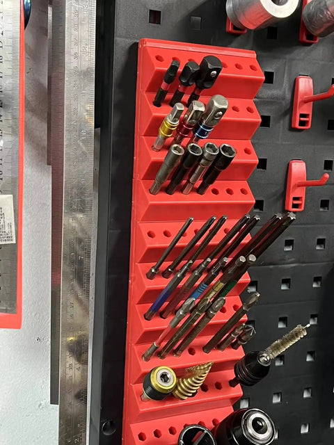 Red 1/4 Inch Hex Bit Organizer with 21 Hole Drill Bit Holder mounted on pegboard, featuring a 45-degree angled design