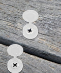 100 Pack Slick Hinged Screw Cap Covers Small White Plastic Dust Shield Plugs on wood surface for fastener protection in DIY projects.