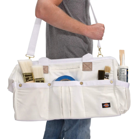 Person holding 20 Inch Heavy Duty Canvas Tool Tote For Painters Carpenters And Builders With Rugged Zipper And Reinforced Handles