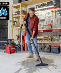Man using Heavy Duty Wet Dry Vac Pro Attachment Kit For Two And A Half Inch Hoses With Seven Foot Dual Flex Hose Industrial Grade Shop Vacuum Accessories For Big Cleanups And Tough Projects to clean wet garage floor