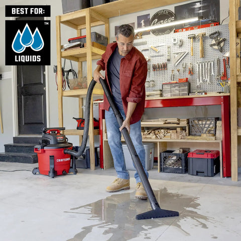 Man using Heavy Duty Wet Dry Vac Pro Attachment Kit For Two And A Half Inch Hoses With Seven Foot Dual Flex Hose Industrial Grade Shop Vacuum Accessories For Big Cleanups And Tough Projects to clean wet garage floor