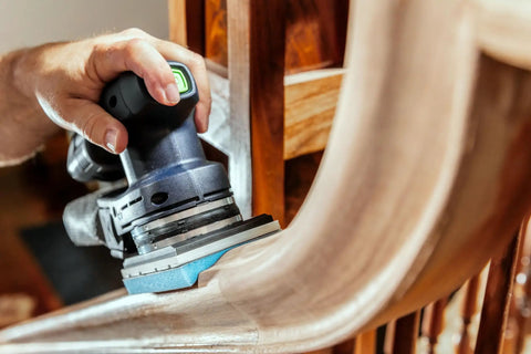 Using Granat Profile Soft Sanding Sheets 80 By 133 Millimeter on curved wooden surface with foam backing for detailed finishing