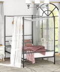 Full Size Metal Canopy Bed Frame With Modern Four Poster Silhouette And Sleek Headboard Matte Black Finish in cozy bedroom setting.