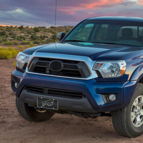 NFL Buffalo Bills Carbon Fiber Metal Auto Tag Paired With Official Vinyl Decals For Your Rig To Flex Big Team Pride and crisp graphics on a blue truck.