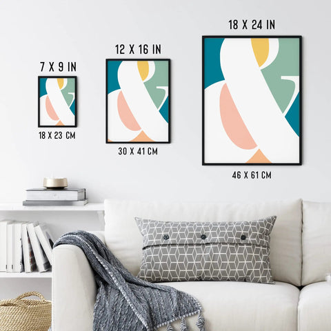 Modern abstract art in three black frames, displayed in sizes 7x9, 12x16, and 18x24 inches on a living room wall above a couch.