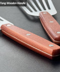 Two stainless steel slotted fish spatulas with wooden full-tang handles; sizes 3x6 and 4x8.