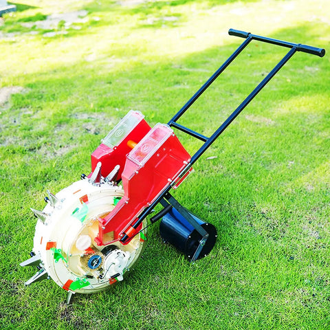 Manual Seed Spreader And Fertilizer Applicator For Garden And Farm Use With Dual Seed And Fertilizer Storage, red, black handle, on grass