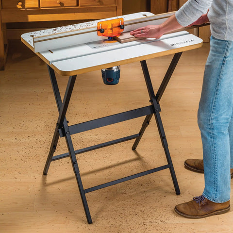 Rock Solid Router Table Kit With Powder Coated Steel Stand And Smooth Phenolic Plate crafted for precision routing in a workspace.
