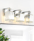Three Light Crystal Bathroom Vanity Light In Chrome Finish mounted above mirror with sleek lux crystal lampshades