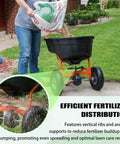 Person using heavy-duty fertilizer spreader with reinforced impeller, showcasing efficient distribution on lawn.