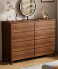 Mid Century Modern Dresser Boasting Eight Spacious Drawers And A Rich Walnut Finish Resting On Robust Wood Legs in a bedroom.