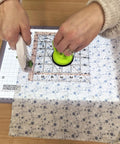 Hands using Portable LED Light Pad For Crafting And Quilting 10 By 13 Inch, Ultra Bright Four Level Illumination For Clear Tracing And Cutting