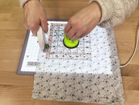 Hands using Portable LED Light Pad For Crafting And Quilting 10 By 13 Inch, Ultra Bright Four Level Illumination For Clear Tracing And Cutting