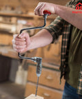 Person using Hand Crank Brace Drill 12.8 Inch With 4 Jaw Chuck For Square End Bits Only Old School Woodworking Tool in a workshop.