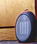 Eco Save Compact Personal Space Heater With 750 Watts ETL Listed Eco Friendly And Energy Efficient Ceramic Heating Element, Space Saver 11 Inch by 7.5 Inch Portable 5 Pound Black Heater in home setting