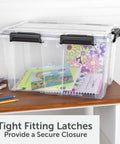 54 Quart Tough As Nails Crystal Clear Storage Tote With IP68 Rated Gasket Sealed Lid and Heavy Duty Secure Latches holding colorful papers.