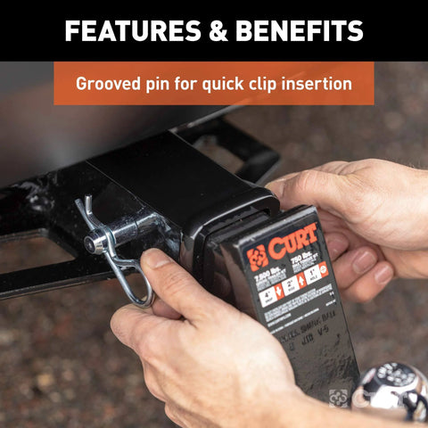Trailer Hitch Pin And Clip With Grooved Head For Easy Installation Five Eighths Inch Diameter Fits Two Inch Receiver Ergonomic Design For Quick No Fuss Use And Durable Trailer Accessory being installed in a 2-inch receiver.