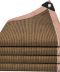 Stacked heavy-duty 90 percent shade cloth with grommets for pergola cover, HDPE mesh tarp in folded layers, visible reinforced edges