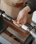 Hand using Pen Press Kit for Woodturning Lathes 2MT Taper Pro Setup with Dual Nylon Pads for nib alignment on lathe