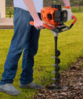 Person using Gas Powered Earth Auger Post Hole Digger 52cc Two Stroke with 1 Extension Rod and 3 Auger Bits in garden