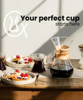 Ottomatic Auto Pour Over Coffee Maker Set With 40 Ounce Capacity, 6 Cup Glass Coffeemaker and breakfast setup on table.