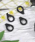 Four black safety washers with unique shape for Heavy Duty Bicycle Hub Nut Set Built Tough Three Eighths Inch Black Flange Axle Nuts