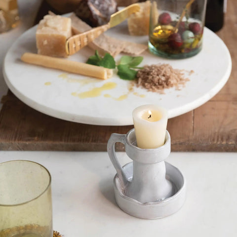 Top Shelf Smooth Spin White Marble Lazy Susan 14 Inch Rolling Turntable For Kitchen Counters And Game Nights with a candle holder.