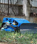 Blue Remote Control RC Lawn Mower With Tracks For Slopes And Rough Terrain cutting grass in a garden setting
