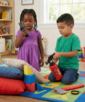 Kids Firefighter Costume Props Set With Water Squirt Fire Extinguisher Toy For Role Play Realistic Fireman Gear With Interphone Megaphone Axe And Toy Radio Perfect For Pretend Play Parties Educational Safety Activities shown in use by children in a playroom.