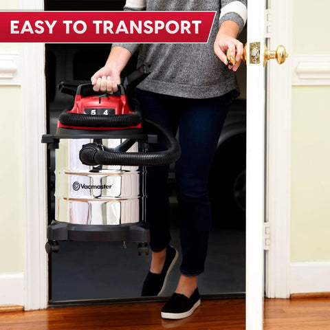 Premium 5 Gallon Wet Dry Shop Vac With Badass 135 Air Watt Suction, Rust Resistant Stainless Steel Tank, 16 Foot Extended Reach, And Six Piece Accessory Bundle For Daily Garage Cleaning being carried through a doorway.
