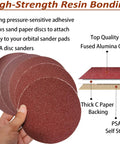 Front view of 6-inch PSA sanding discs with sticky backing; assorted grits (80-400) in red abrasive, held in hand