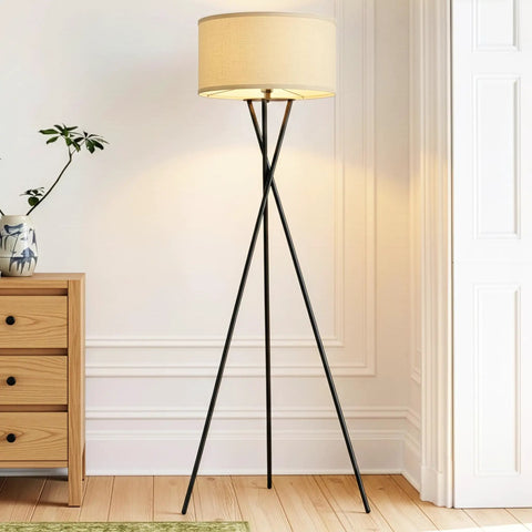 LED Floor Lamp Tall Tripod With Drum Shade In Black Finish And Gold Accents in a modern living room setting