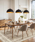 Esfos 11.8" Black and Gold Pendant Lights Kitchen Island, 3 Pack Chandelier hanging above a modern dining table.