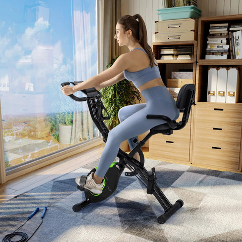 Crush Your Cardio Game On This Smooth Five In One Folding Exercise Bike Featuring Sixteen Level Magnetic Resistance And Rock Solid Three Hundred Pound Build, user pedaling indoors.