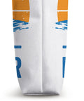 Close-up side seam of Work Hard Foil Harder Wing Foil Wingsurfing Tote Bag with blue and orange design