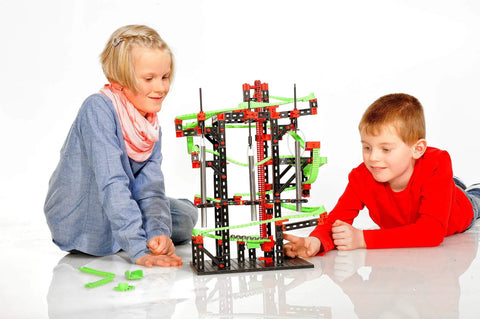 Dynamic M Set With 515 Parts For Four Buildable Models, Rotary Funnel, Sound Tubes, Cross Over, Five 90 Degree Curves, Steel Balls For Melodic Tones, Manual Chain Lift, A Solid STEM Toy Your Kids Will Totally Love. shown with two children