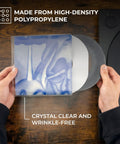 Hands inserting vinyl into Crystal Clear 3 Mil 7 Inch Vinyl Outer Sleeves Pack 100 Count Durable Polypropylene Covers for LPs and Singles