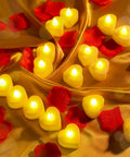 6000 Artificial Rose Petals And 72 Heart Shaped LED Tealights For Romantic Nights Valentines Weddings Proposals And Anniversary Decor With Warm White Light displayed on golden fabric with scattered petals and glowing candles