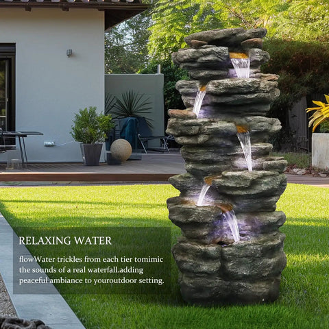 40 Inch High Six Tier Cascading Rock Outdoor Water Fountain With LED Lights installed in garden setting